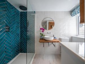 a bathroom with a sink and a mirror at Blackberry Cottage - Newly renovated cosy cottage in Malborough +29 photos