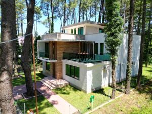 a house in the middle of a forest at Pine Aparthotel in Shekvetili