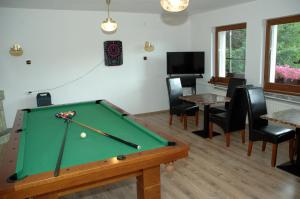 a living room with a pool table and chairs at ORION in Karpacz