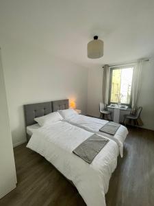 a bedroom with two beds with white sheets and a window at Cozy and central Apartment Lübeck in Lübeck