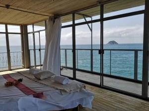a bedroom with a bed with a view of the ocean at Mawo house in Santana