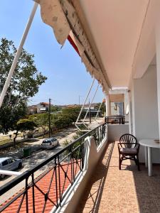 a balcony with a table and a chair and a view at Dimitra House Entire apartment with balcony and view in Pherrai