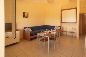 a living room with a table and a couch at Medimare Residence Club in Patti