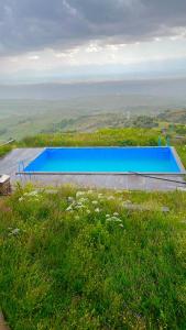 a large blue swimming pool on top of a hill at Lernarot Guest House 