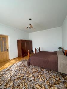 a bedroom with a bed and a dresser and a door at Lernarot Guest House in Lernarot