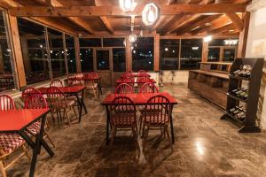 a dining room with red tables and chairs at Cordial Cappadocia Hotel in Ortahisar