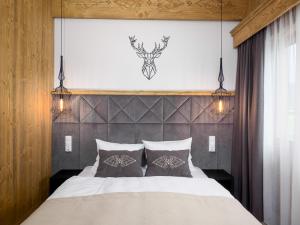 a bedroom with a bed with two pillows at Apartamenty Górski Prestige in Białka Tatrzanska
