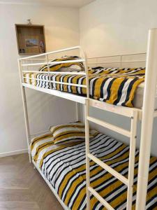 a couple of bunk beds in a room at Maison de pêcheur Bachelet Home in Trouville-sur-Mer