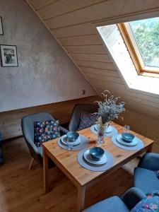 a dining room with a wooden table and chairs at Olimp pokoje i apartamenty in Szczyrk