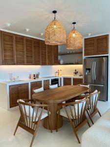 a kitchen with a wooden table and chairs at White Pearl Villa in Dhërmi
