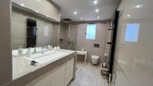 a bathroom with a sink and a shower and a toilet at Maison de village chez Audrey in Ramatuelle +8 photos