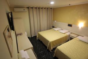 Postel nebo postele na pokoji v ubytování Hotel Três Fronteiras