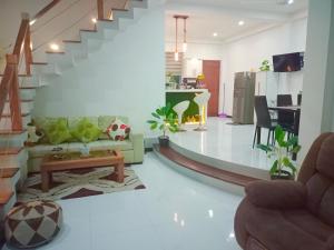 a living room with a couch and a staircase at Kurulu Villa Hikkaduwa in Gonapinuwala West