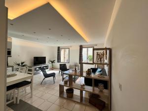 a living room with a table and a dining room at Maison de village chez Audrey in Ramatuelle