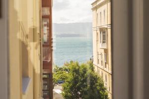 a view of the ocean from a window of a building at Plaza Cuatro in Santander