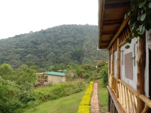 a house with a view of a mountain at Buhoma Community Haven lodge 
