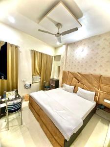 1 dormitorio con 1 cama grande y TV en Swaran hotel en Amritsar