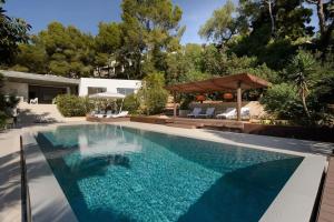 a swimming pool in the backyard of a house at Mordern Villa - Sea view - Near Eivissa old town in Can Furnet