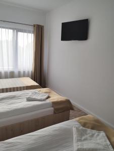 מיטה או מיטות בחדר ב-Casa Darius Cluj