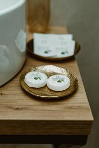two white towels on a plate on a table at ARINI WHITE HOUSE in Sibiu +30 photos