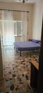 a bedroom with two beds and a stone floor at BELLO E LUMINOSO in Florence