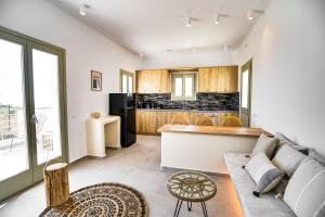 a living room with a couch and a kitchen at Acria Villas in Pyrgos