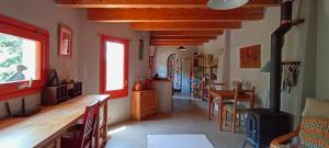 a living room with a kitchen and a dining room at Can Parròquia in Sant Esteve de Palautordera