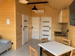 a kitchen and dining room with a table in a room at RYBY W SIECI in Władysławowo