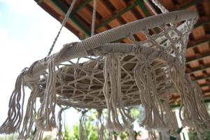 a wicker chandelier hanging from a roof at Η μονοκατοικία της Χαράς. in Kalamáki