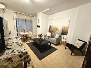 a living room with a couch and a table at Hotel Wellamar in Sant Feliu de Guíxols