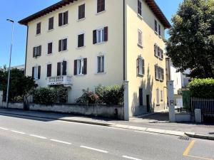 a white building on the side of a street at Loft Università 4 posti letto in Bergamo