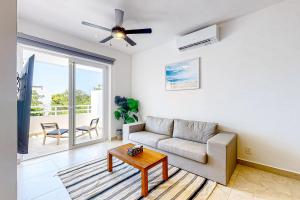 a living room with a couch and a table at La Selva 303 Sirenis in Akumal