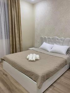 a bedroom with a bed with two pillows on it at MT House in Batumi
