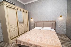 a bedroom with a large bed in a room at Hotel Black Sea in Sukhum