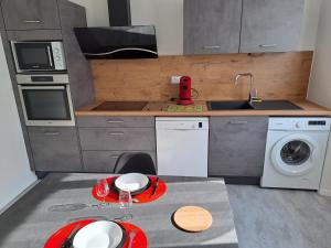 a kitchen with a sink and a washing machine at Agréable T2 Classé 3 étoiles, refait à neuf, dans quartier calme in Rodez +15 photos