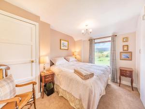 a bedroom with a large bed and a window at Pennine View in Long Marton