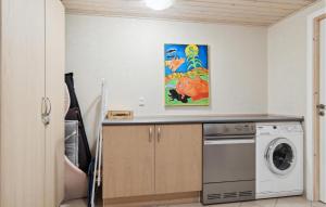 a laundry room with a washer and dryer at Stunning Home In Esbjerg V With Kitchen in Esbjerg
