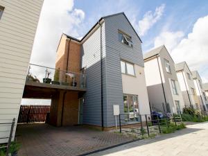 a gray house with a balcony on a street at Pass the Keys Stunning Newcastle Home in Elswick