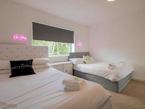 a bedroom with two beds and a window at Pass the Keys Stunning Newcastle Home in Elswick