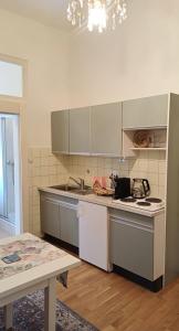 a kitchen with a sink and a stove top oven at City Apartment am Lendkanal, Klagenfurt in Klagenfurt