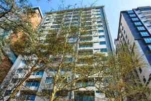a tall building with trees in front of it at Lovely instantworthy Premier One Bedroom Apartment in Nairobi