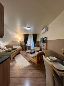 a living room with a couch and a table at Holler Vendégház in Bük