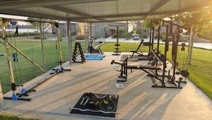 a gym with several tread machines in a pavilion at Real Life Homes luxurious seafront villas each with their own private pools in Korakokhórion