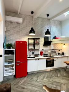 a kitchen with a red refrigerator in a room at Casa Hugo - Guest Suites in Fort-de-France