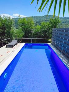 a swimming pool with a view of the mountains at Apartman Verona in Buzet