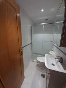 a bathroom with a shower and a toilet and a sink at Apartamento El Horrín ( Colunga ) in Colunga