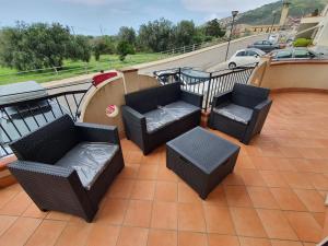 balkon z kanapami i krzesłami na patio w obiekcie Appartamento Vacanza Mare Gioiosa Marea Zappardino w mieście Gioiosa Marea