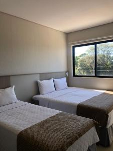 Cama ou camas em um quarto em Iguassu Express Hotel