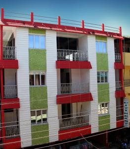 an apartment building with red and white balconies at Hotel Citi Heart in Port Blair
