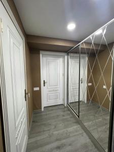 a hallway with a white door and a walk in closet at Aylin Boutique Hotel in Gabala